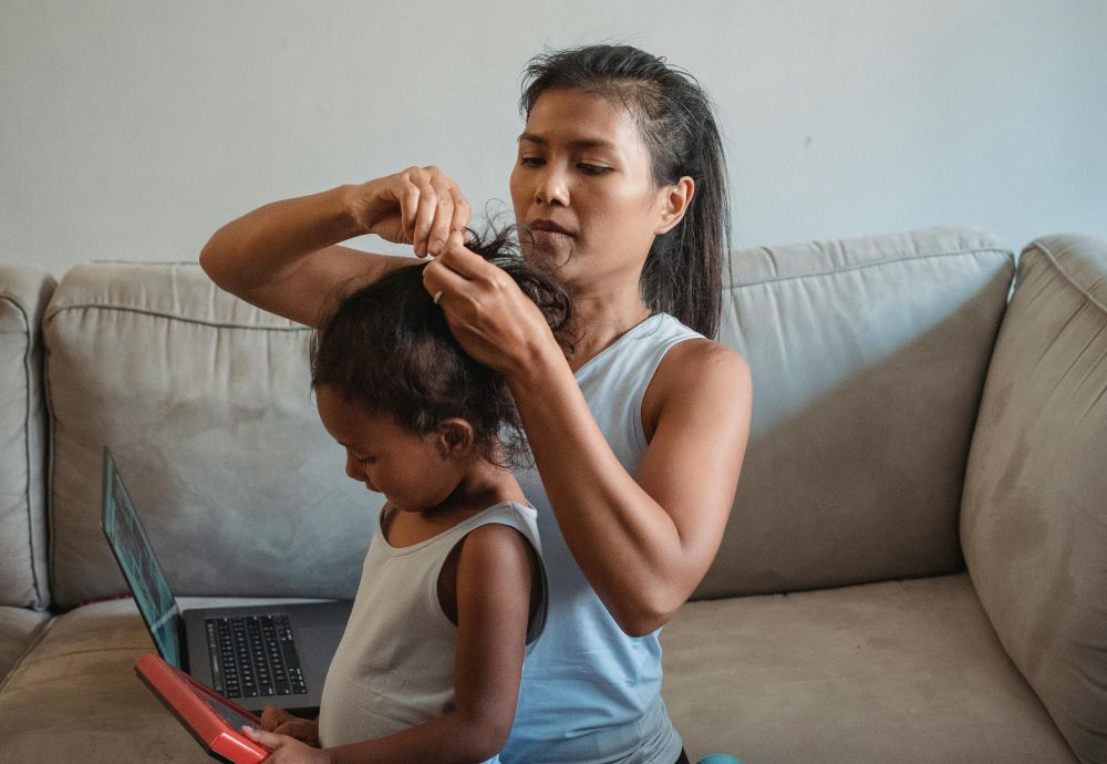 Woman prepares a girl's hair. Woman prepares a girl's hair.